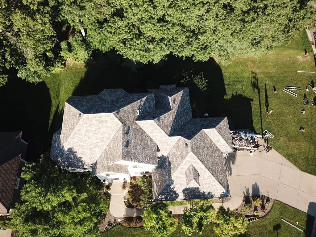 Aerial view of a multi-gable home with a newly installed architectural shingle roof