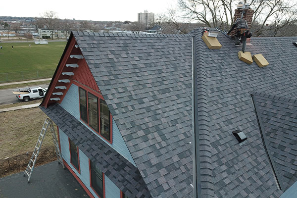 Roof R Us worker repairing a roof in Minneapolis, MN.