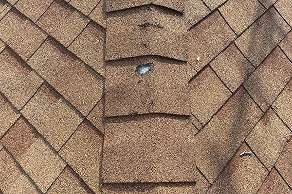 Damaged brown roof that needs repair Minneapolis